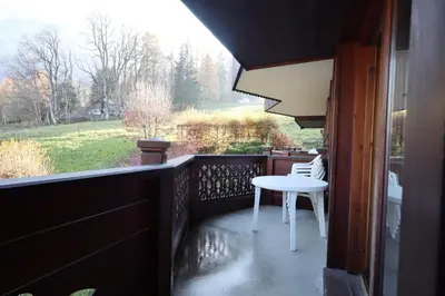 a balcony with a white table and chairs on it at Résidence Les Hauts De Chavants - Hauts de Chavants Berard 10 MAE-6415 in Les Houches