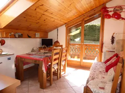 a kitchen with a table and a dining room at Chalets Alpages - Chalets Alpages 4 MAE-6417 in Les Houches