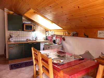 a small kitchen with a table and a stove at Chalets Alpages - Chalets Alpages 4 MAE-6417 in Les Houches