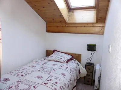a bedroom with a bed and a window at Chalets Alpages - Chalets Alpages 4 MAE-6417 in Les Houches