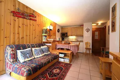a living room with a couch and a kitchen at Résidence Les Aiguilles Rouges Bat B - Aiguilles Rouges B6 MAE-6418 in Les Houches