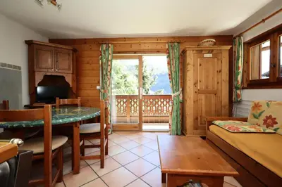 a living room with a table and a couch at Résidence Les Hauts De Chavants - Hauts de Chavants Berard 01 MAE-6419 in Les Houches
