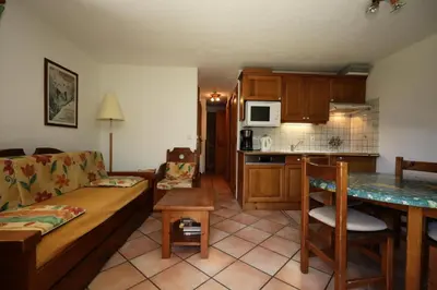 a living room with a couch and a kitchen at Résidence Les Hauts De Chavants - Hauts de Chavants Berard 01 MAE-6419 in Les Houches
