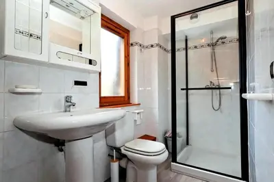 a bathroom with a sink and a toilet and a shower at Résidence Beauregard - Beauregard 6 MAE-6421 in Les Houches
