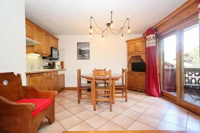 a kitchen with a table and a dining room at Résidence Les Hauts De Chavants - Hauts de Chavants Berard 04 MAE-6426 in Les Houches