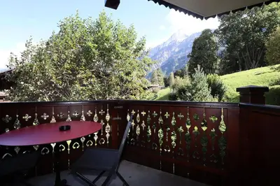 a balcony with a table and a view of a mountain at Résidence Les Hauts De Chavants - Hauts de Chavants Berard 04 MAE-6426 in Les Houches