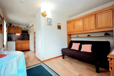 a living room with a couch and a kitchen at Résidence Le Prarion 2 C - Prarion 2 28 MAE-6429 in Les Houches
