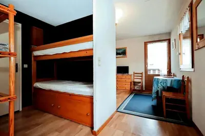 a bedroom with two bunk beds and a table at Résidence Le Prarion 2 C - Prarion 2 28 MAE-6429 in Les Houches
