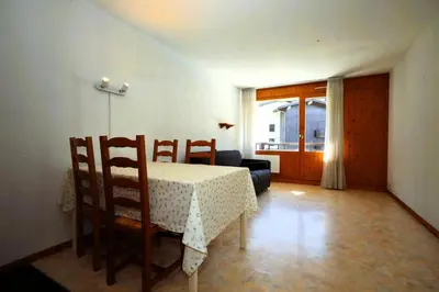 a dining room with a table and chairs and a couch at Résidence Le Prarion 2 C - Prarion 2 C13 MAE-6430 in Les Houches