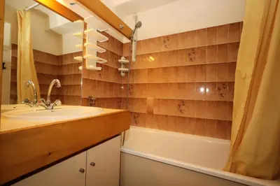 a bathroom with a sink and a tub at Résidence Le Prarion 2 C - Prarion 2 C13 MAE-6430 in Les Houches