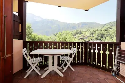 a table and chairs on a balcony with a view at Résidence Le ChÂteau Bruyeres - Château B42 MAE-6432 in Les Houches