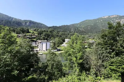 a view of a town and a river with mountains at Résidence Le ChÂteau Bruyeres - Château B42 MAE-6432 in Les Houches