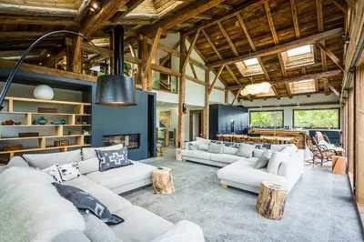 a large living room with couches and windows at Chalet Léandre in Les Houches