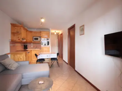 a living room with a couch and a table at Appartement Central 6 Pers, Parking, Ascenseur, Proche Pistes et Commerces - FR-1-572-22 in Les Carroz d'Araches
