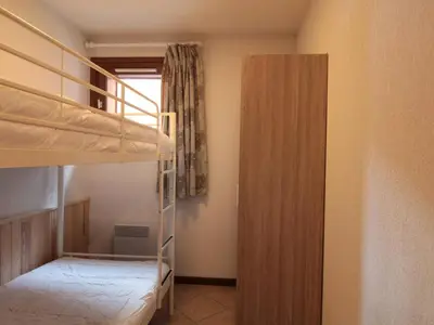 a bedroom with two bunk beds and a closet at Appartement Central 6 Pers, Parking, Ascenseur, Proche Pistes et Commerces - FR-1-572-22 in Les Carroz d'Araches