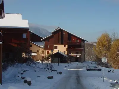 a snow covered road in front of a building at Appartement Central 6 Pers, Parking, Ascenseur, Proche Pistes et Commerces - FR-1-572-22 in Les Carroz d'Araches