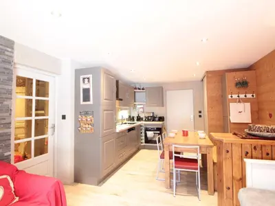 a kitchen with a table and a dining room at Appartement cosy 6 pers. au centre du village, proche des pistes et commerces - FR-1-572-52 in Les Carroz d'Araches