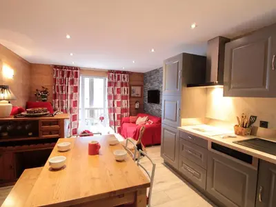 a kitchen with a wooden table in a room at Appartement cosy 6 pers. au centre du village, proche des pistes et commerces - FR-1-572-52 in Les Carroz d'Araches