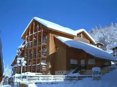 a large building with snow on the roof at Appartement cosy 6 pers. au centre du village, proche des pistes et commerces - FR-1-572-52 in Les Carroz d'Araches