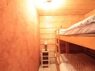 a small room with two bunk beds and a lamp at Appartement cosy 6 pers. au centre du village, proche des pistes et commerces - FR-1-572-52 in Les Carroz d'Araches