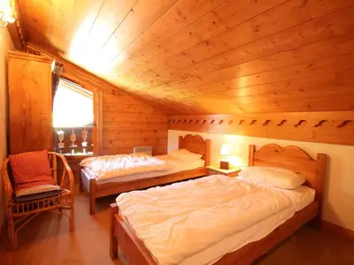 a bedroom with two beds in a wooden cabin at Duplex chaleureux 4 pièces avec wifi, parking, proche spa & bus pour ski - FR-1-572-43 in Les Carroz d'Araches