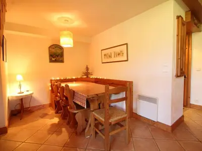 a dining room with a table and chairs at Duplex chaleureux 4 pièces avec wifi, parking, proche spa & bus pour ski - FR-1-572-43 in Les Carroz d'Araches