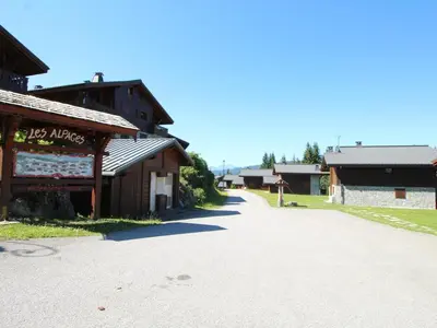 an empty road in front of a building at Duplex chaleureux 4 pièces avec wifi, parking, proche spa & bus pour ski - FR-1-572-43 in Les Carroz d'Araches