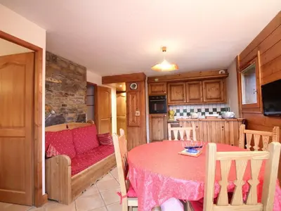 a kitchen with a table and a dining room at 3 pièces cabine avec parking, près des pistes et commerces - FR-1-572-55 in Les Carroz d'Araches