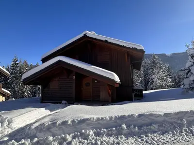 a cabin covered in snow with a pile of snow at 3 pièces cabine avec parking, près des pistes et commerces - FR-1-572-55 in Les Carroz d'Araches