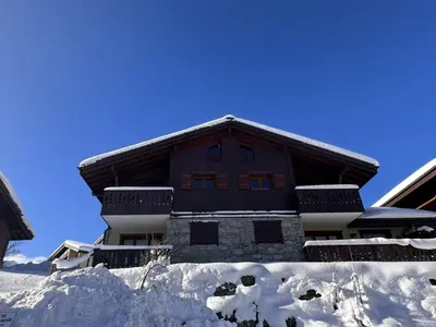 a building with snow in front of it at 3 pièces cabine avec parking, près des pistes et commerces - FR-1-572-55 in Les Carroz d'Araches