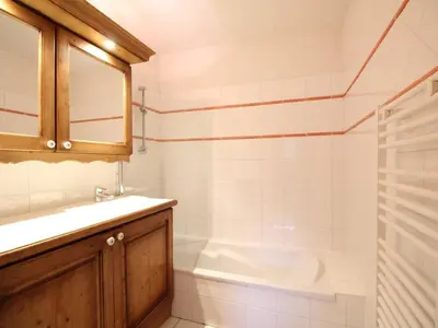 a bathroom with a sink and a bath tub at 3 pièces cabine avec parking, près des pistes et commerces - FR-1-572-55 in Les Carroz d'Araches