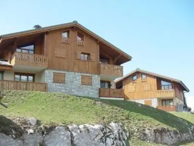 a large building on top of a hill at 3 pièces cabine avec parking, près des pistes et commerces - FR-1-572-55 in Les Carroz d'Araches