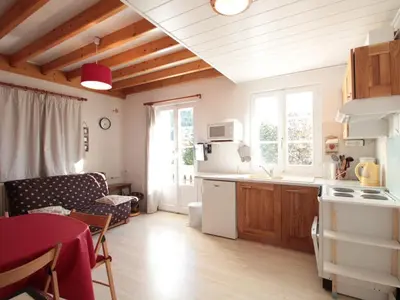 a kitchen and living room with a table and a couch at Duplex 3 pièces pour 6 pers, centre-village, proche pistes et commerces - FR-1-572-78 in Les Carroz d'Araches