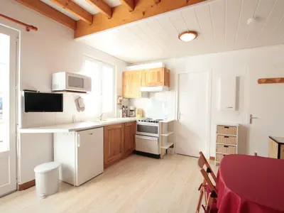 a kitchen with white appliances and a table with chairs at Duplex 3 pièces pour 6 pers, centre-village, proche pistes et commerces - FR-1-572-78 in Les Carroz d'Araches