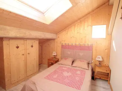 a bedroom with a bed in a room with a skylight at Duplex 3 pièces pour 6 pers, centre-village, proche pistes et commerces - FR-1-572-78 in Les Carroz d'Araches