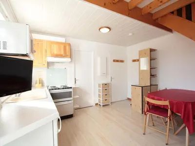 a kitchen and dining room with a table in a room at Duplex 3 pièces pour 6 pers, centre-village, proche pistes et commerces - FR-1-572-78 in Les Carroz d'Araches