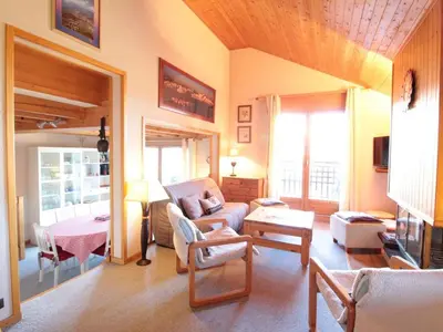 a living room with a couch and a table at Appartement 8 pers, 4 pièces, 50m des pistes, parking, balcon, proche commerces - FR-1-572-88 in Les Carroz d'Araches