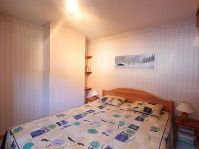 a bedroom with a bed with a quilt on it at Appartement 8 pers, 4 pièces, 50m des pistes, parking, balcon, proche commerces - FR-1-572-88 in Les Carroz d'Araches