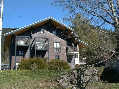 a large house with balconies on the side of it at Appartement 8 pers, 4 pièces, 50m des pistes, parking, balcon, proche commerces - FR-1-572-88 in Les Carroz d'Araches