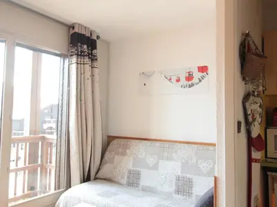a bedroom with a bed and a window at Studio chaleureux 4 pers, centre village, proche pistes et commerces, balcon sud-ouest - FR-1-572-105 in Les Carroz d'Araches