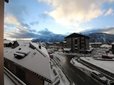a city with snow covered buildings and a mountain at Studio chaleureux 4 pers, centre village, proche pistes et commerces, balcon sud-ouest - FR-1-572-105 in Les Carroz d'Araches