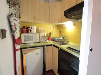 a small kitchen with a sink and a microwave at Studio chaleureux 4 pers, centre village, proche pistes et commerces, balcon sud-ouest - FR-1-572-105 in Les Carroz d'Araches