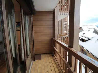 a balcony of a house with wooden walls at Studio chaleureux 4 pers, centre village, proche pistes et commerces, balcon sud-ouest - FR-1-572-105 in Les Carroz d'Araches
