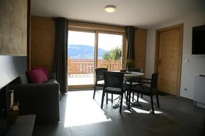 a living room with a table and chairs and a couch at Le Mazot d'la Marmotte Studio in Passy
