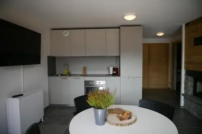 a kitchen with a table with a plate of food on it at Le Mazot d'la Marmotte Studio in Passy