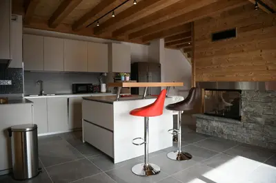 a living room with a couch and a spiral staircase at Le Mazot d'la Marmotte T3 in Passy