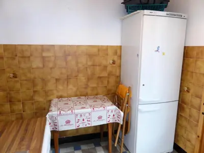 a small kitchen with a table and a refrigerator at Chalet Pylone - Chalet Pylone MAE-5198 in Saint-Gervais-les-Bains
