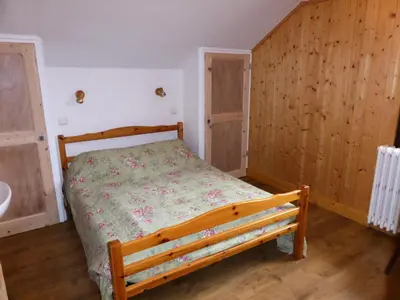 a bedroom with a bed and wooden walls and wooden floors at Chalet Pylone - Chalet Pylone MAE-5198 in Saint-Gervais-les-Bains