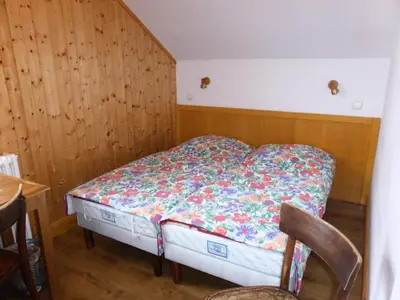 a small bed in a room with wooden walls at Chalet Pylone - Chalet Pylone MAE-5198 in Saint-Gervais-les-Bains