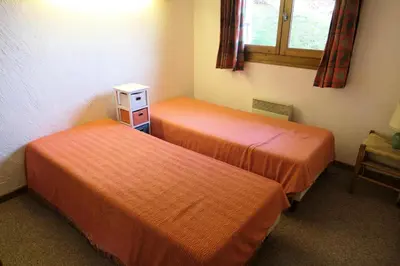 two orange beds in a room with a window at Chalet Saint Nicolas - Chalet Saint-Nicolas MAE-5203 in Saint-Gervais-les-Bains